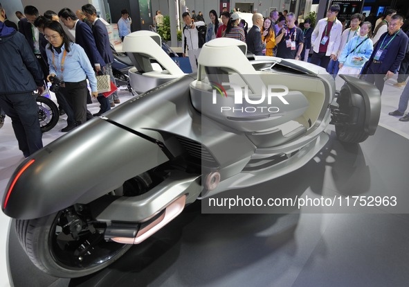 Visitors look at the Yamaha TRICERA electric three-wheel concept car at the 7th CIIE in Shanghai, China, on November 6, 2024. 