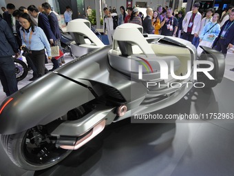 Visitors look at the Yamaha TRICERA electric three-wheel concept car at the 7th CIIE in Shanghai, China, on November 6, 2024. (