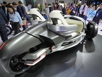 Visitors look at the Yamaha TRICERA electric three-wheel concept car at the 7th CIIE in Shanghai, China, on November 6, 2024. (