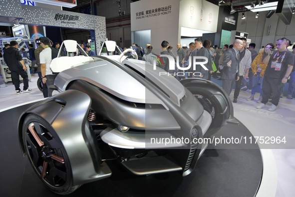 Visitors look at the Yamaha TRICERA electric three-wheel concept car at the 7th CIIE in Shanghai, China, on November 6, 2024. 