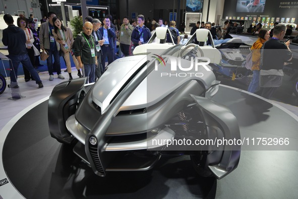 Visitors look at the Yamaha TRICERA electric three-wheel concept car at the 7th CIIE in Shanghai, China, on November 6, 2024. 