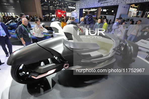 Visitors look at the Yamaha TRICERA electric three-wheel concept car at the 7th CIIE in Shanghai, China, on November 6, 2024. 