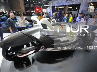 Visitors look at the Yamaha TRICERA electric three-wheel concept car at the 7th CIIE in Shanghai, China, on November 6, 2024. (