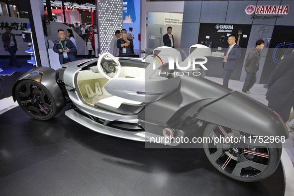 Visitors look at the Yamaha TRICERA electric three-wheel concept car at the 7th CIIE in Shanghai, China, on November 6, 2024. 