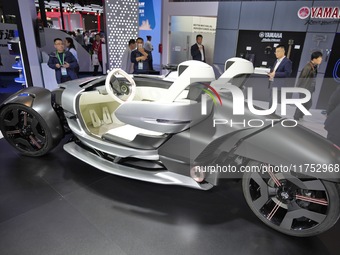 Visitors look at the Yamaha TRICERA electric three-wheel concept car at the 7th CIIE in Shanghai, China, on November 6, 2024. (