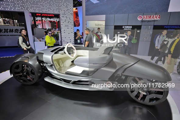 Visitors look at the Yamaha TRICERA electric three-wheel concept car at the 7th CIIE in Shanghai, China, on November 6, 2024. 