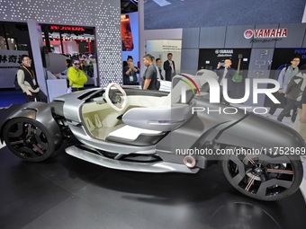 Visitors look at the Yamaha TRICERA electric three-wheel concept car at the 7th CIIE in Shanghai, China, on November 6, 2024. (