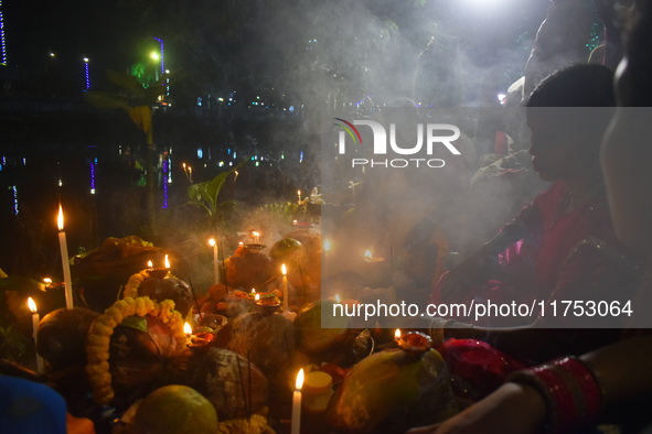 Hindu devotees prepare offerings as they worship the Sun God during the Hindu religious festival of Chhath Puja in Kolkata, India, on Novemb...