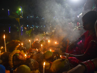 Hindu devotees prepare offerings as they worship the Sun God during the Hindu religious festival of Chhath Puja in Kolkata, India, on Novemb...