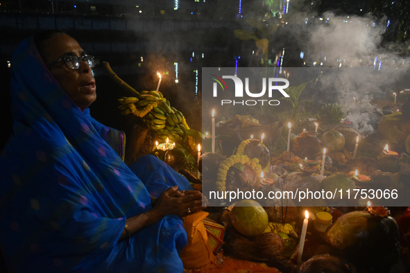 Hindu devotees prepare offerings as they worship the Sun God during the Hindu religious festival of Chhath Puja in Kolkata, India, on Novemb...