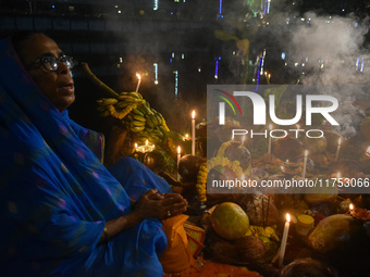 Hindu devotees prepare offerings as they worship the Sun God during the Hindu religious festival of Chhath Puja in Kolkata, India, on Novemb...