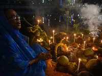 Hindu devotees prepare offerings as they worship the Sun God during the Hindu religious festival of Chhath Puja in Kolkata, India, on Novemb...