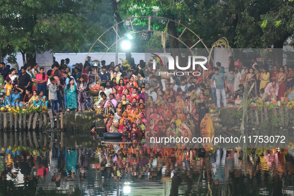 Hindu women worship the Sun god in the early morning during the religious festival of Chhath Puja at a pond in Kolkata, India, on November 8...