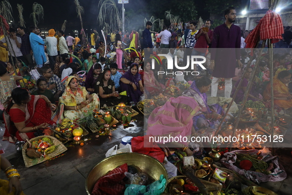 Hindu devotees hold offerings at dawn as they offer prayers to the Sun god on the banks of the river Ganges during the last day of the Hindu...