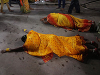 A Hindu devotee lies on the road as she worships the Sun god at dawn on the banks of the river Ganges during the last day of the Hindu relig...