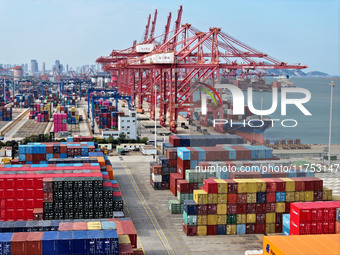 Cargo ships stop at their berths to load and unload containers at the container terminal in Lianyungang Port in Lianyungang, China, on Novem...