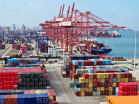 Cargo ships stop at their berths to load and unload containers at the container terminal in Lianyungang Port in Lianyungang, China, on Novem...