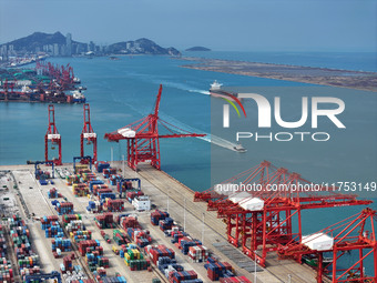 Cargo ships stop at their berths to load and unload containers at the container terminal in Lianyungang Port in Lianyungang, China, on Novem...