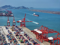 Cargo ships stop at their berths to load and unload containers at the container terminal in Lianyungang Port in Lianyungang, China, on Novem...