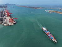 Cargo ships stop at their berths to load and unload containers at the container terminal in Lianyungang Port in Lianyungang, China, on Novem...