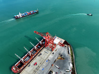 Cargo ships stop at their berths to load and unload containers at the container terminal in Lianyungang Port in Lianyungang, China, on Novem...