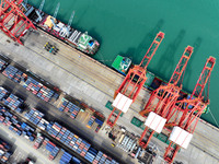 Cargo ships stop at their berths to load and unload containers at the container terminal in Lianyungang Port in Lianyungang, China, on Novem...