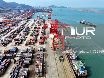 Cargo ships stop at their berths to load and unload containers at the container terminal in Lianyungang Port in Lianyungang, China, on Novem...