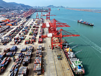 Cargo ships stop at their berths to load and unload containers at the container terminal in Lianyungang Port in Lianyungang, China, on Novem...