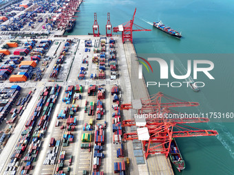 Cargo ships stop at their berths to load and unload containers at the container terminal in Lianyungang Port in Lianyungang, China, on Novem...