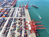 Cargo ships stop at their berths to load and unload containers at the container terminal in Lianyungang Port in Lianyungang, China, on Novem...