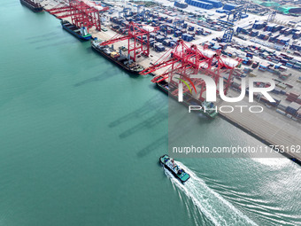 Cargo ships stop at their berths to load and unload containers at the container terminal in Lianyungang Port in Lianyungang, China, on Novem...