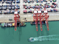 Cargo ships stop at their berths to load and unload containers at the container terminal in Lianyungang Port in Lianyungang, China, on Novem...