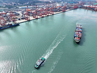 Cargo ships stop at their berths to load and unload containers at the container terminal in Lianyungang Port in Lianyungang, China, on Novem...