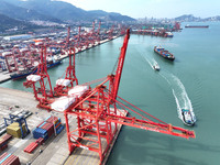 Cargo ships stop at their berths to load and unload containers at the container terminal in Lianyungang Port in Lianyungang, China, on Novem...