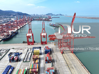 Cargo ships stop at their berths to load and unload containers at the container terminal in Lianyungang Port in Lianyungang, China, on Novem...