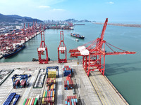 Cargo ships stop at their berths to load and unload containers at the container terminal in Lianyungang Port in Lianyungang, China, on Novem...