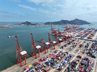 Cargo ships stop at their berths to load and unload containers at the container terminal in Lianyungang Port in Lianyungang, China, on Novem...