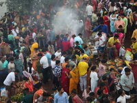 Hindu devotees hold offerings at dawn as they offer prayers to the Sun god on the banks of the river Ganges during the last day of the Hindu...