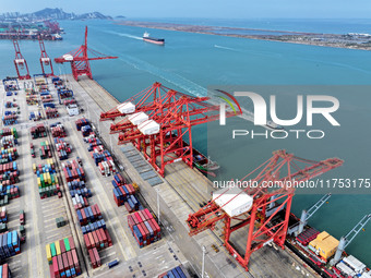 Cargo ships stop at their berths to load and unload containers at the container terminal in Lianyungang Port in Lianyungang, China, on Novem...