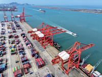 Cargo ships stop at their berths to load and unload containers at the container terminal in Lianyungang Port in Lianyungang, China, on Novem...