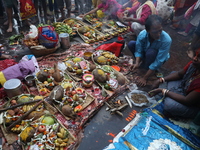 Hindu devotees hold offerings during the early morning as they offer prayers to the Sun god on the banks of the river Ganges during the last...