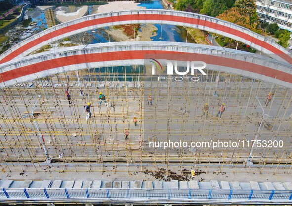 Workers carry out maintenance work on the Nanyuan Bridge in Yuexi County, Anqing City, East China's Anhui Province, on November 8, 2024. 