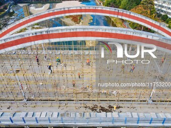 Workers carry out maintenance work on the Nanyuan Bridge in Yuexi County, Anqing City, East China's Anhui Province, on November 8, 2024. (