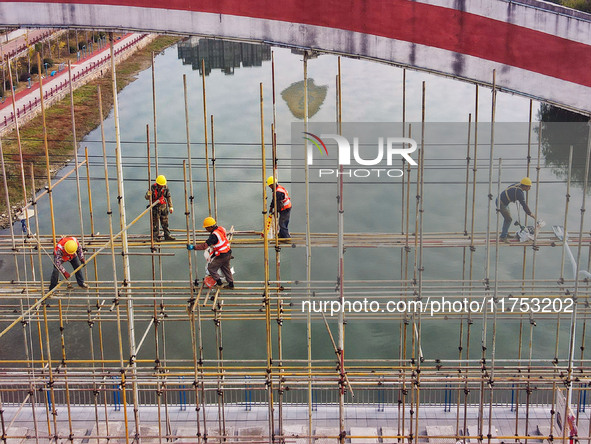 Workers carry out maintenance work on the Nanyuan Bridge in Yuexi County, Anqing City, East China's Anhui Province, on November 8, 2024. 