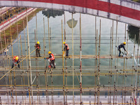 Workers carry out maintenance work on the Nanyuan Bridge in Yuexi County, Anqing City, East China's Anhui Province, on November 8, 2024. (