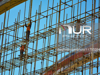 Workers carry out maintenance work on the Nanyuan Bridge in Yuexi County, Anqing City, East China's Anhui Province, on November 8, 2024. (