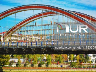 Workers carry out maintenance work on the Nanyuan Bridge in Yuexi County, Anqing City, East China's Anhui Province, on November 8, 2024. (