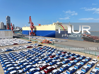 A roll-on wheel is loaded with cars for export at the terminal of Orient Port Branch in Lianyungang Port in Lianyungang, China, on November...