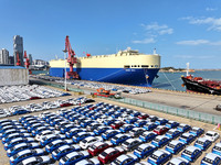 A roll-on wheel is loaded with cars for export at the terminal of Orient Port Branch in Lianyungang Port in Lianyungang, China, on November...