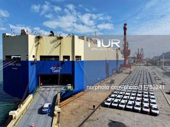 A roll-on wheel is loaded with cars for export at the terminal of Orient Port Branch in Lianyungang Port in Lianyungang, China, on November...